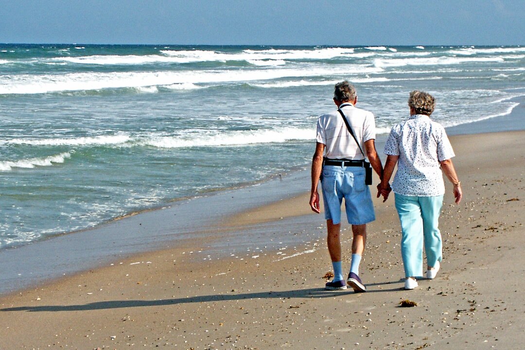 senior couple walking on beach